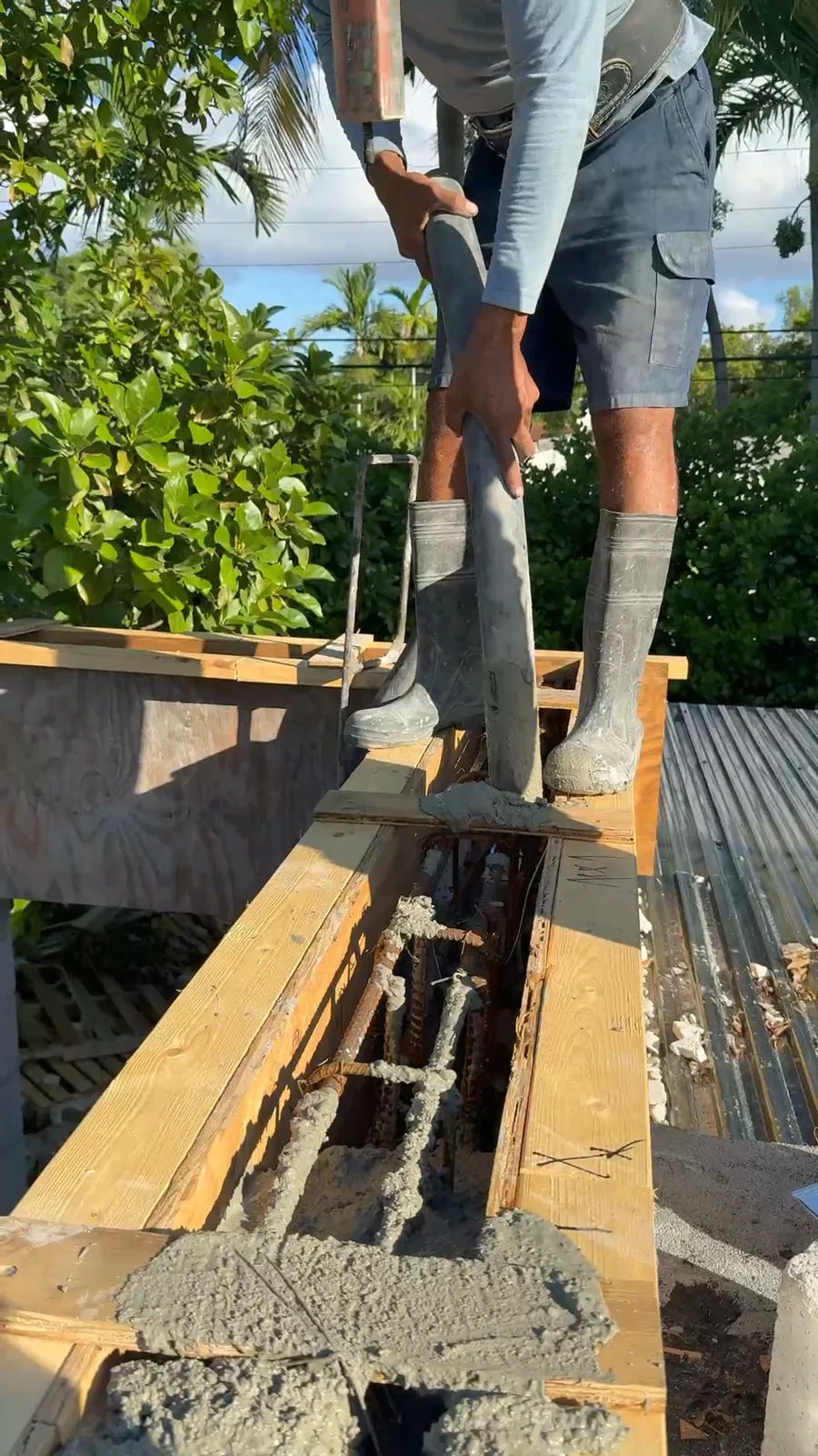 Concrete being placed into a reinforced beam form