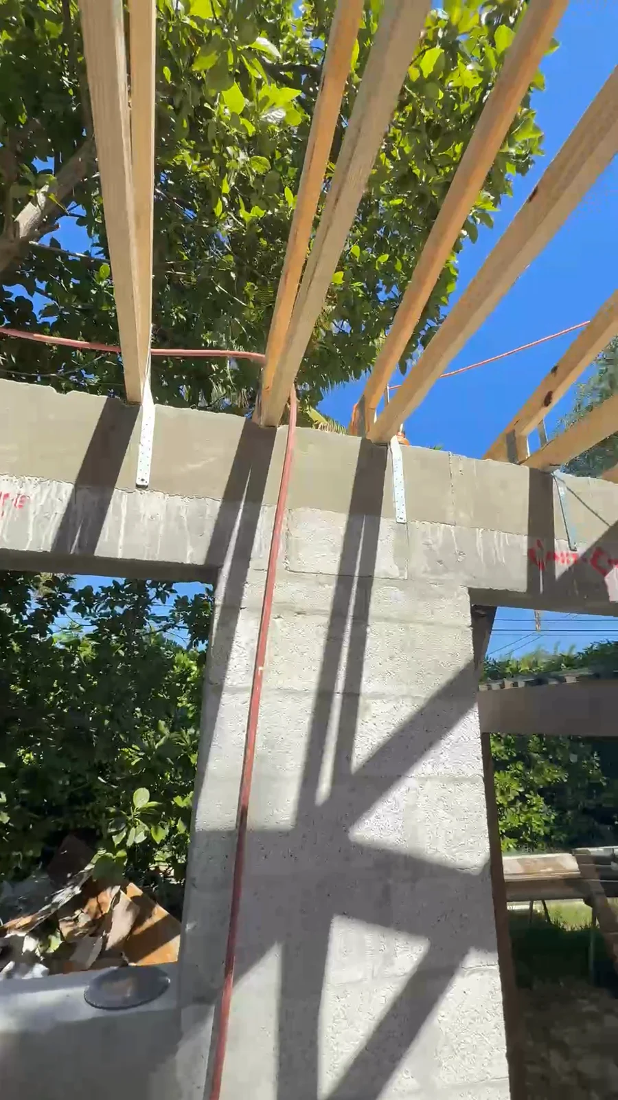 Wood roof framing and straps over CMU walls